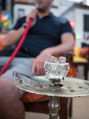 Man smokes shisha outdoor,  unhealthy concept