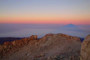 Teide Peak (the highest point in Spain - 3718 metres) casting its shadow like a pyramid at the sunrise, Tenerife, Canary islands, Spain