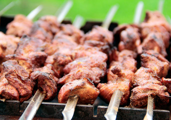 the meat on the skewers on the grill