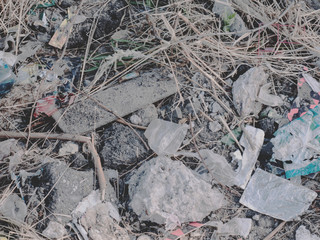 Polluted nature full of trash with no people. Grungy abstract urban background texture top view. Big city environmental ghetto. Faded garbage region with room for text. Real world photography.