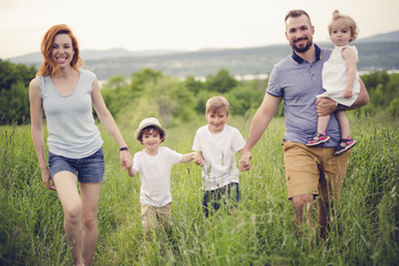 Fototapeta premium Happy family in the meadow