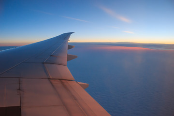 Fototapeta na wymiar Photo of airplane wing and sunrise sky