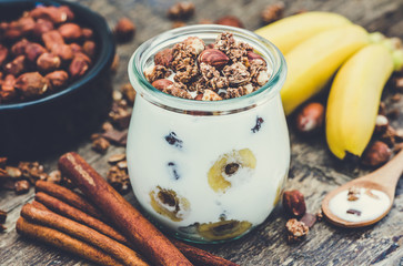 Serving of Yogurt with  Muesli, Banana and Nuts. Vintage Effect.