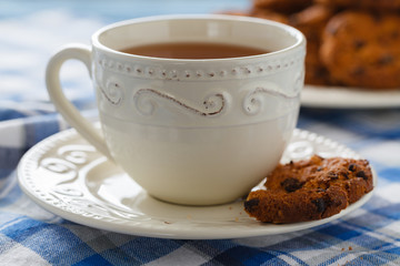 Cup of tea with oatmeal cookies on a wooden background