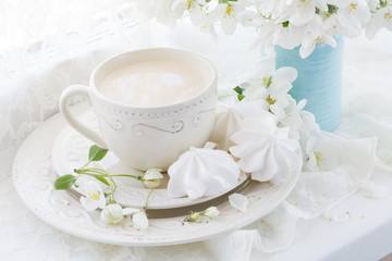 Obraz na płótnie Canvas Still life with tea cup and blossom branch