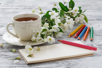 Love card in summer bouquet of gentle blooming apple and tea in china teacup
