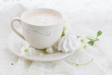 Romantic composition with tea cup, zephyr and apple flowers