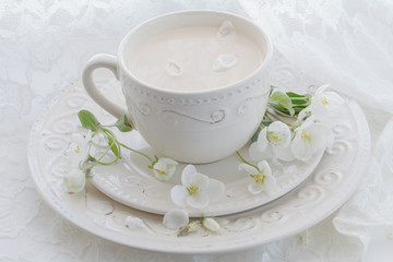 Romantic composition with tea cup, zephyr and apple flowers
