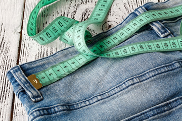 tape measuring on jeans