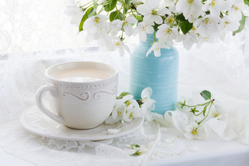 Still life with tea cup and blossom branch