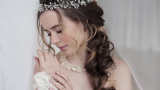 Closeup brunette bride with fashion wedding hairstyle and makeup