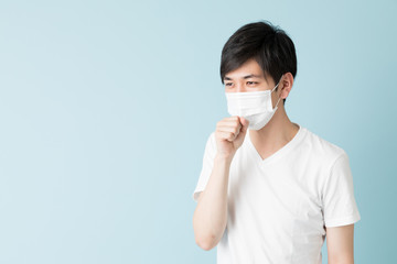 portrait of young asian man isolated on blue background