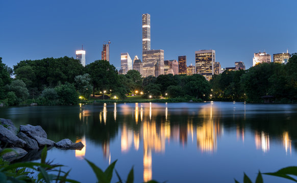 Illuminated Skyline Reflected in the Lake in Central Park, New York City