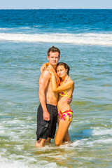 Young American Couple traveling, relaxing on the beach in New Jersey, USA