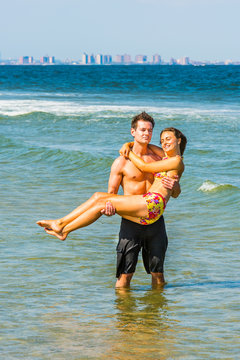 Young American Couple traveling, relaxing on the beach in New Jersey, USA