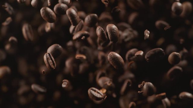 Coffee beans fly after being exploded. Shot with high speed camera, phantom flex 4K. Slow Motion.