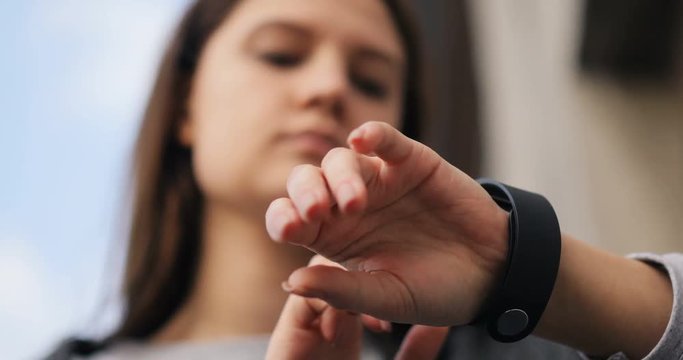 Close up woman using her smartwatch, smart watch closeup 4k hand device gadget app touch time looking using