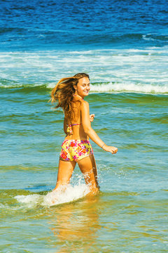 Happy Young Woman Wading on Water.