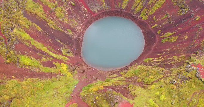 ICELAND &ndash; SEPTEMBER 2016 : Aerial shot of Kerid Crater Lake on a beautiful day with people hiking in view