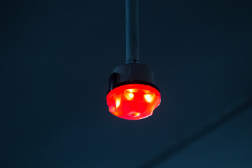 Car Parking lot sensor on white ceiling  Indicator Light show unoccupied is red
