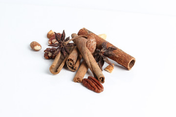 Cinnamon sticks with star anise and almond isolated with white background