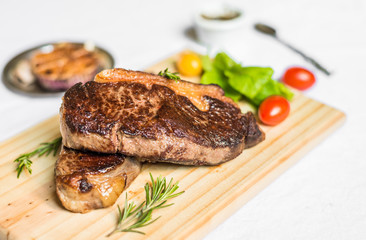 New york strip porterhouse steak meat with vegetables against white background