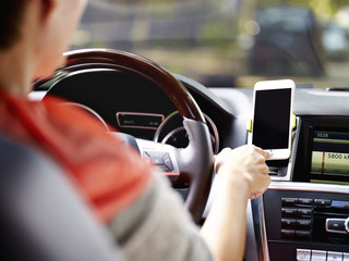 woman using cellphone before driving