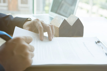 realtor explain mortgage loan agreement to his client.  real estate agent or house developer...