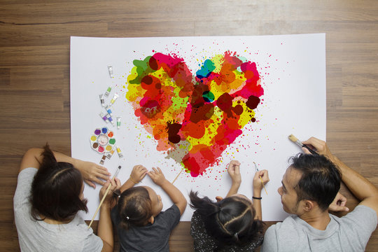 Colorful Heart With Happy Family Lying Painting Brush Watercolor, Top View Creative Photo On Wooden Floor In Her Room At Home