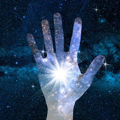 conceptual image of hand and universe © jokerpro