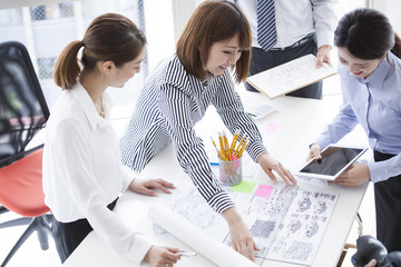 They are making meetings while watching the design drawing