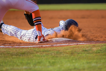 Baseball player sliding first base