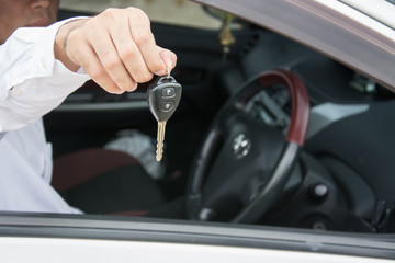 Hand with a car keys in car