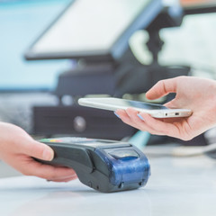 Close up of mobile payment in a shop.