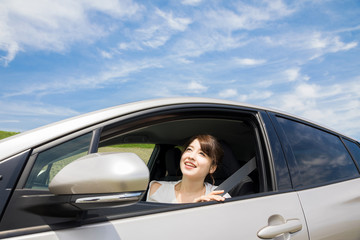 young woman showing her face from car window.
