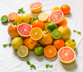 A large assortment of colorful citrus fruit (lemon, lime, orange, grapefruit, mandarin, tangerine, pomelo)