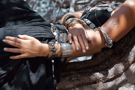 Tribal woman dancer outdoors. Close up photo of hands with ethnic jewelry