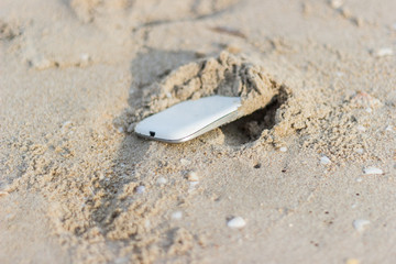 Fototapeta na wymiar Mobile phone floated to the sea at the beach.