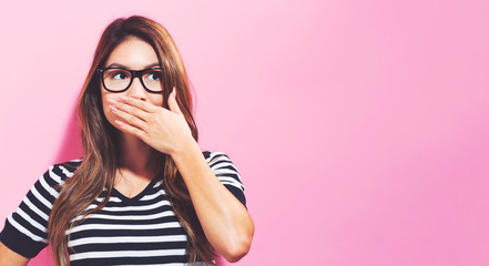 Young woman covering her mouth