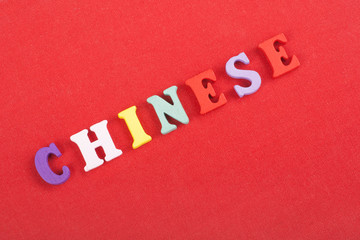 Fototapeta na wymiar CHINESE word on red background composed from colorful abc alphabet block wooden letters, copy space for ad text. Learning english concept.