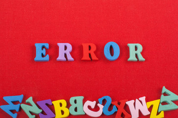 ERROR word on red background composed from colorful abc alphabet block wooden letters, copy space for ad text. Learning english concept.