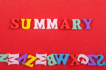 Fototapeta na wymiar SUMMARY word on red background composed from colorful abc alphabet block wooden letters, copy space for ad text. Learning english concept.