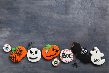 Fresh halloween gingerbread cookies on grey wooden table