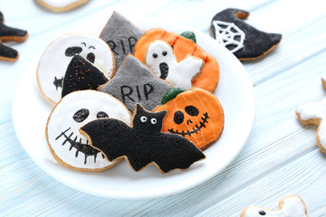 Fresh halloween gingerbread cookies on blue wooden table