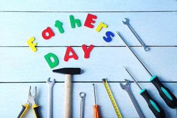Different tools for fathers day on blue wooden table