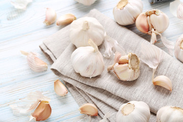 Garlic with napkin on blue wooden table