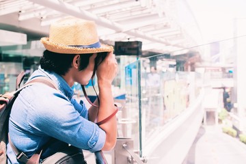 Asian man tourist taking photo at modern building, Travel concept