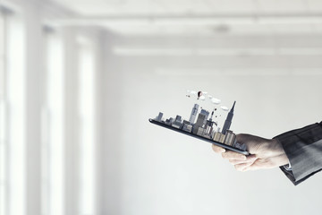 Tablet in woman hand. Mixed media