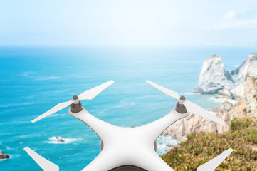 Drone with digital camera flying over the sea
