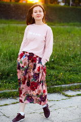 The stylish girl walking along alley